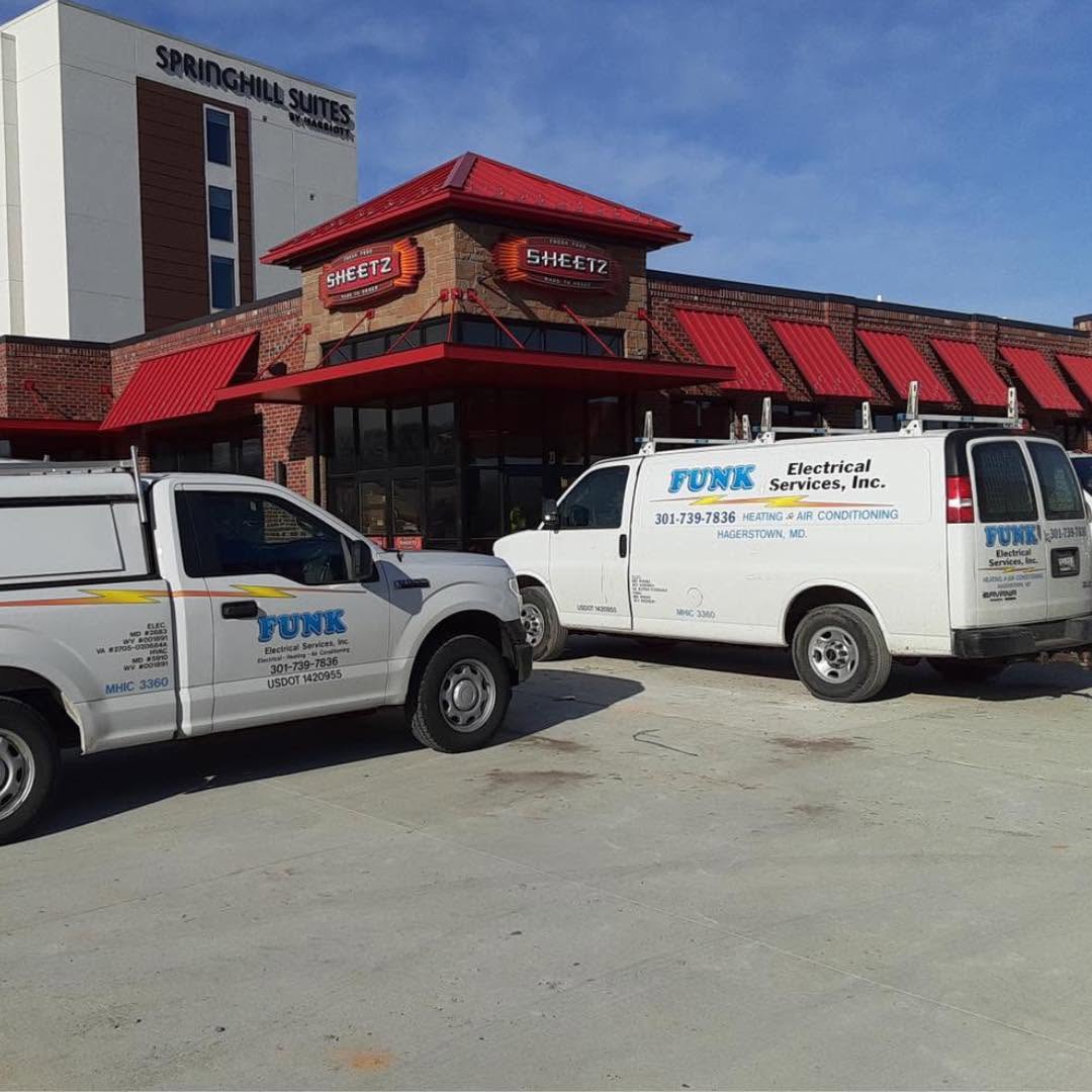 Funk Electrical service vans on a commercial job site